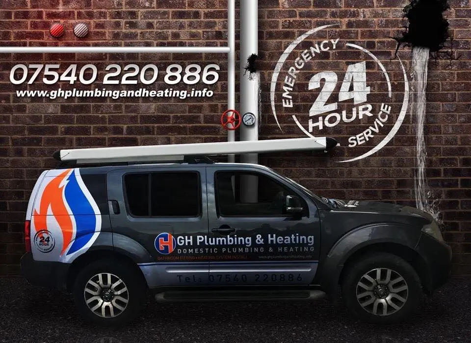 The GH Plumbing and Heating van, a grey estate with the company name, flame logo and phone number on its side